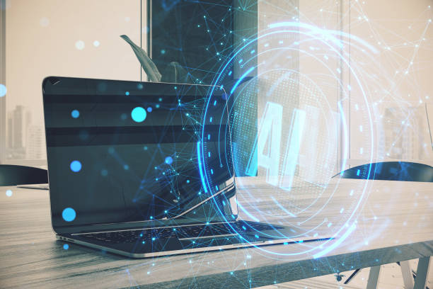 Close up of laptop on light blurry workplace background with glowing blue AI hologram. Artificial intelligence, technology and innovation concept